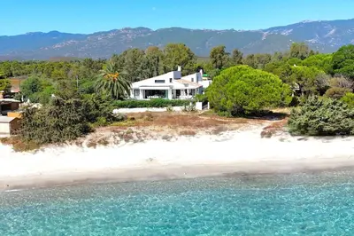 an aerial view of a house on an island in the water at Villa San Ciprianu Mare Di Lecci in Lecci