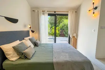 a bedroom with a large bed with pillows on it at Villa San Ciprianu Mare Di Lecci in Lecci