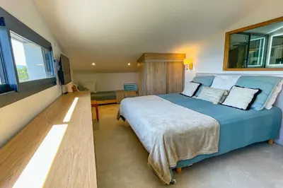 a bedroom with a large blue bed in a room at Villa San Ciprianu Mare Di Lecci in Lecci
