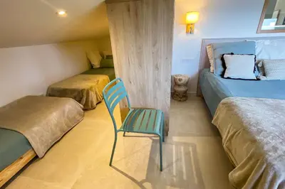 a room with two beds and a chair in it at Villa San Ciprianu Mare Di Lecci in Lecci