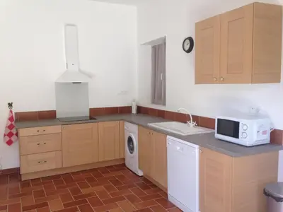 a kitchen with a sink and a microwave in it at A FATA DI L'ORTOLO gîtes à la ferme in Sartène