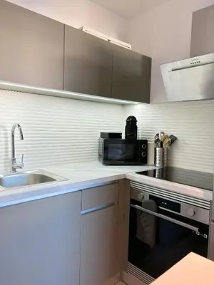 a kitchen with a sink and a microwave at Charmant appartement à Ajaccio, proche de la mer ! in Ajaccio