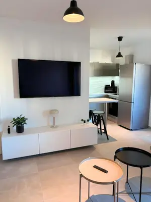 a living room with a flat screen tv on a wall at Charmant appartement à Ajaccio, proche de la mer ! in Ajaccio