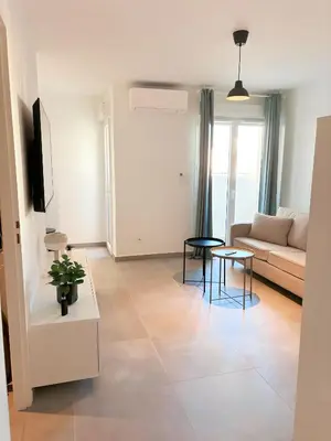 a living room with a couch and a table at Charmant appartement à Ajaccio, proche de la mer ! in Ajaccio