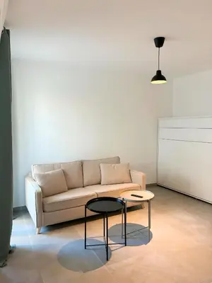 a living room with a couch and a table at Charmant appartement à Ajaccio, proche de la mer ! in Ajaccio