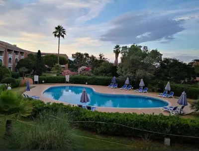 a pool with chairs and umbrellas in a yard at Doalchaléda in Linguizzetta