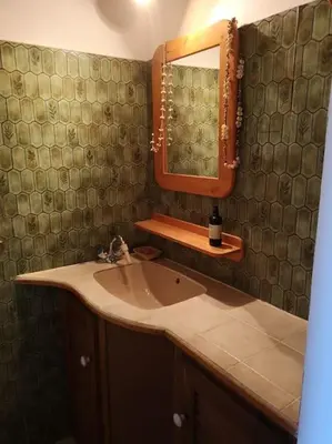 a bathroom with a sink and a mirror at La Tour dans haut de villa in Porto-Vecchio