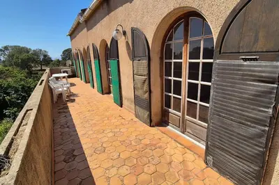 a building with a row of windows and a patio at T4 Furesta - Casa Mattea in Aléria