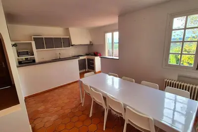 a kitchen with a large white table and chairs at T4 Furesta - Casa Mattea in Aléria