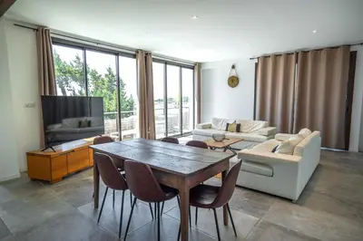 a living room with a table and a couch at Hotel L'Escale in Porto Pollo