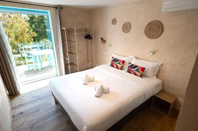 a bedroom with a bed with two towels on it at Hotel L'Escale in Porto Pollo