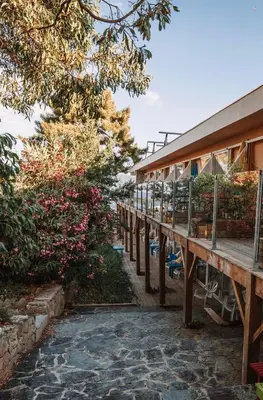 a walkway in front of a building with plants at Hotel L'Escale in Porto Pollo