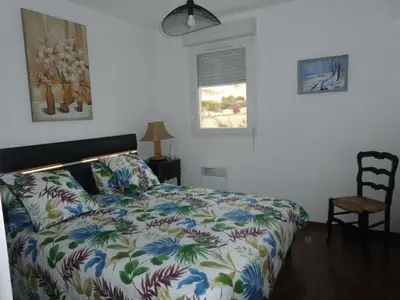 a bedroom with a bed with a colorful comforter at Ajaccio Sanguinaires T3 proche Trottel et 150m de la mer, belle résidence in Ajaccio