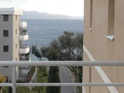 a view of the ocean from a balcony of a building at Ajaccio Sanguinaires T3 proche Trottel et 150m de la mer, belle résidence in Ajaccio