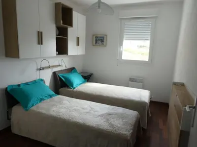 a room with two beds and a window at Ajaccio Sanguinaires T3 proche Trottel et 150m de la mer, belle résidence in Ajaccio