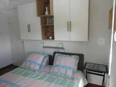 a bed with two pillows in a small room at Ajaccio Sanguinaires T3 proche Trottel et 150m de la mer, belle résidence in Ajaccio