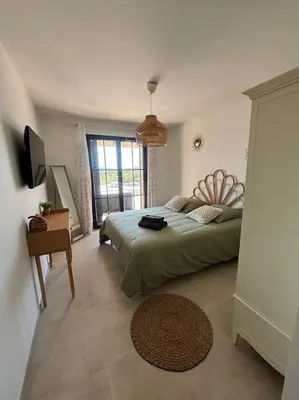 a bedroom with a bed and a television in it at Casa Nostra in Olmeto