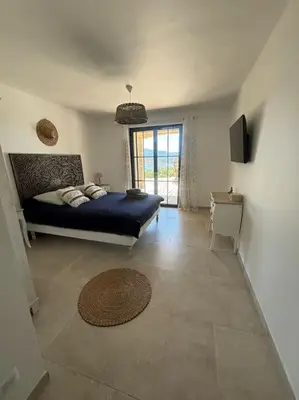 a bedroom with a bed and a television in a room at Casa Nostra in Olmeto