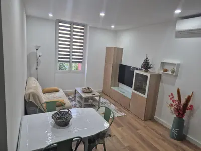 a living room with a table and a tv at Trottel a Livia in Ajaccio