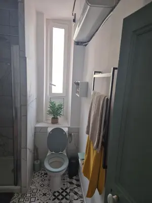 a bathroom with a toilet and a window at Trottel a Livia in Ajaccio