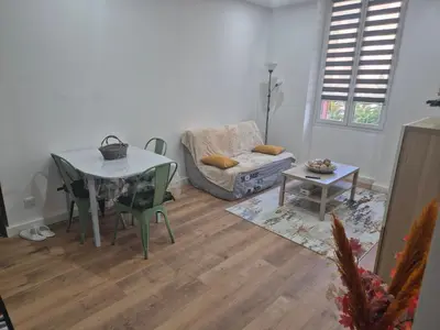 a living room with a table and a couch at Trottel a Livia in Ajaccio