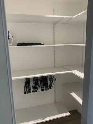 a white closet with white shelving at Appartement F4 pour 6 personnes in Ajaccio