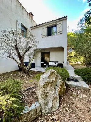 a large rock in front of a house at Maison T4 Saint Cyprien in Lecci