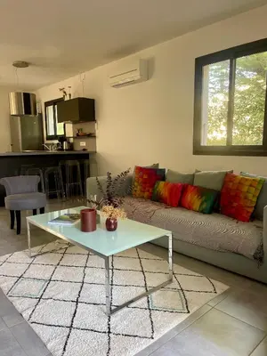 a living room with a couch and a table at Maison T4 Saint Cyprien in Lecci