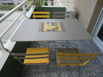 a table and chairs on a balcony at Ajaccio Sanguinaires T2 150métres de la mer in Ajaccio