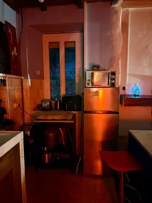 a kitchen with a microwave on top of a refrigerator at Maison de village in Zevaco