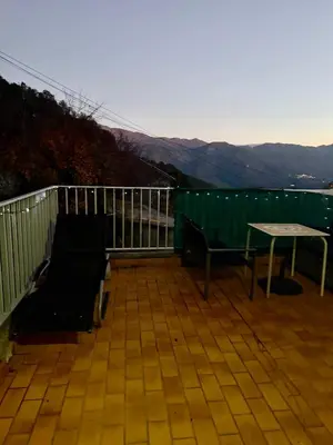 a patio with a table and a bench on a balcony at Maison de village in Zevaco