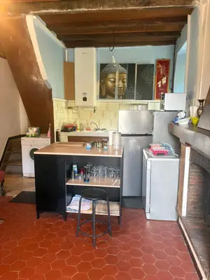 a kitchen with a bar with a black head on the wall at Maison de village in Zevaco