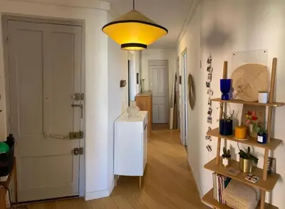 a hallway with a white refrigerator and a light at T4 Pieds dans l'eau ! in Ajaccio