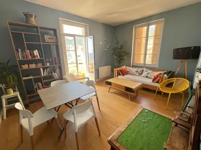 a living room with a couch and a table at T4 Pieds dans l'eau ! in Ajaccio