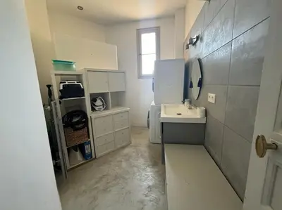 a white bathroom with a sink and a window at T4 Pieds dans l'eau ! in Ajaccio