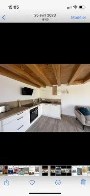 a kitchen with white cabinets and a black appliance at Appartement Oriana in Montegrosso