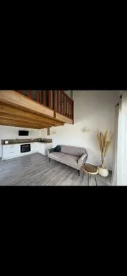 a living room with a couch and a table at Appartement Oriana in Montegrosso