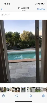 a view of a swimming pool through a sliding glass door at Appartement Oriana in Montegrosso