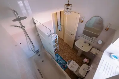 a bathroom with a tub and a toilet and a sink at Le Jardin d'Irène Vue panoramique exceptionnelle sur la Méditerranée in Cargèse