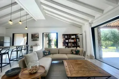 a living room with a couch and a table at Villa à Marina di Fiori - 8 pers in Porto-Vecchio
