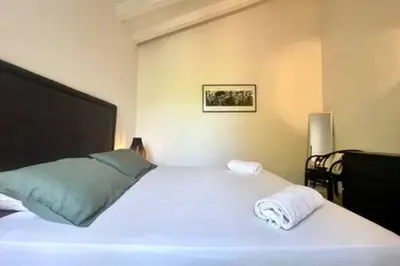 a bedroom with a large white bed with two pillows at Villa à Marina di Fiori - 8 pers in Porto-Vecchio