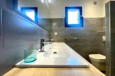 a bathroom with a sink and a toilet at Villa à Marina di Fiori - 8 pers in Porto-Vecchio