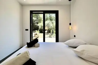 a large white bed in a room with a window at Casa di Macchjerolu - 8 pers in Sotta