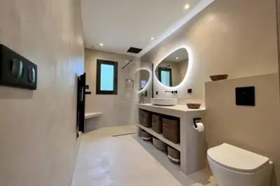 a bathroom with a toilet and a sink and a mirror at Casa di Macchjerolu - 8 pers in Sotta