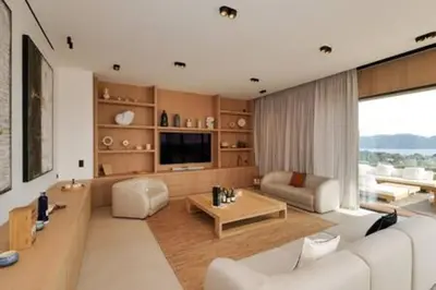 a living room with a white couch and a television at Villa Wooden Horizon - Mer Montagne 18 pers in Porto-Vecchio