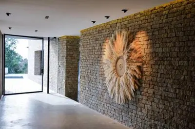 a brick wall with a clock on the side of it at Villa Wooden Horizon - Mer Montagne 18 pers in Porto-Vecchio