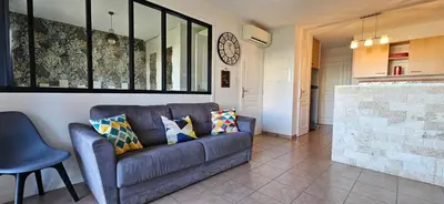 a living room with a couch and a fireplace at Beau T3 Central - Vue mer & Piscine - A Funtana in Propriano