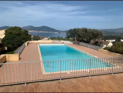 a swimming pool on top of a house at Appartement accès piscine collective Porticcio Corse du sud in Porticcio