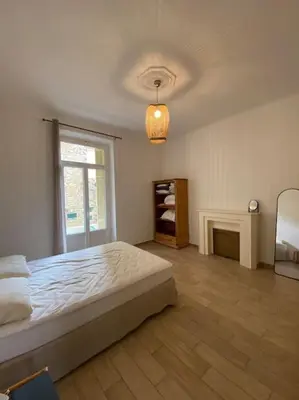 a white bedroom with a bed and a window at appartement Cyrnos 3Pc 73m2 in Ajaccio