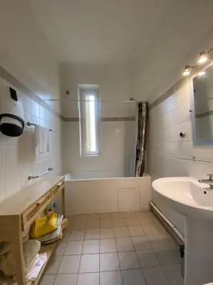a white bathroom with a tub and a sink at appartement Cyrnos 3Pc 73m2 in Ajaccio